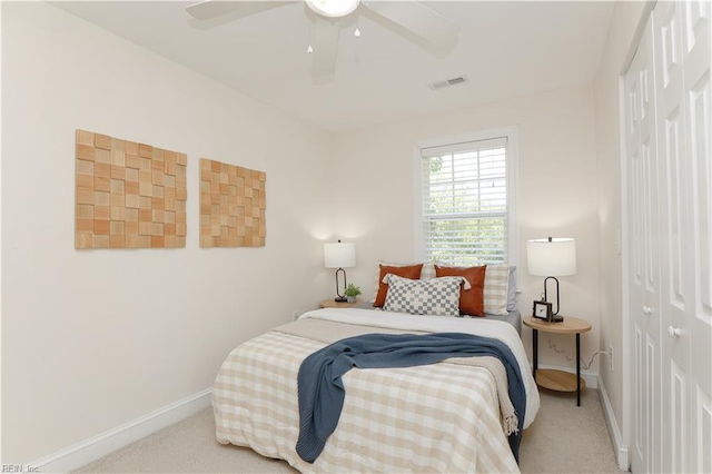 bedroom featuring carpet, a ceiling fan, baseboards, visible vents, and a closet