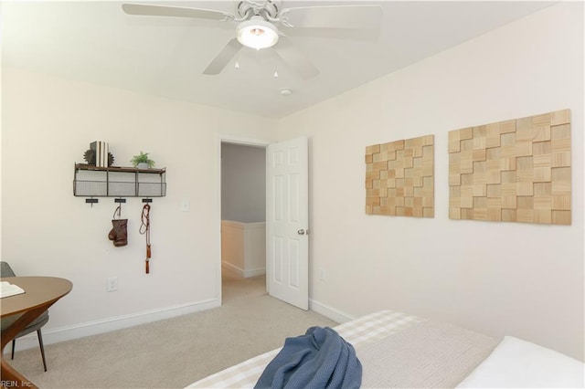 bedroom with a ceiling fan, baseboards, and carpet