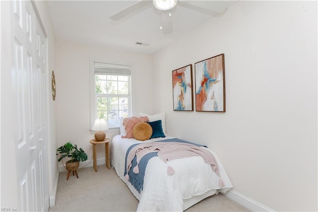 bedroom with carpet flooring, a ceiling fan, baseboards, and a closet