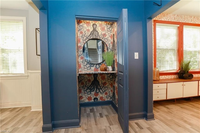 interior details featuring wainscoting and wood finished floors