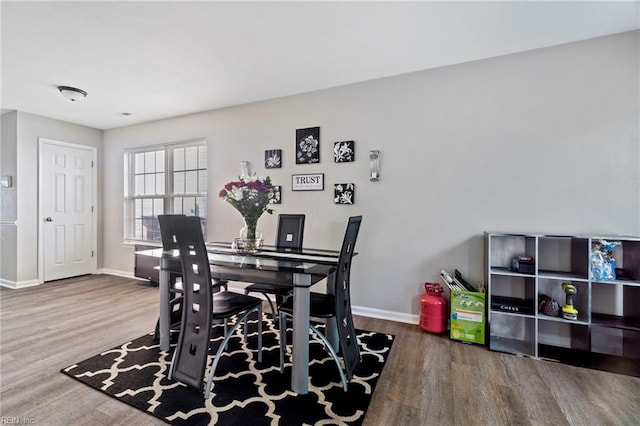 dining room featuring baseboards and wood finished floors