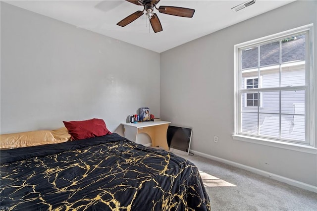 carpeted bedroom featuring a ceiling fan, baseboards, visible vents, and multiple windows