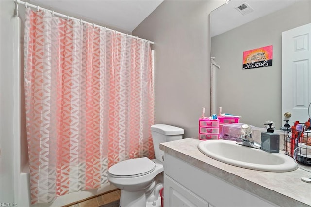 full bathroom with vanity, shower / tub combo, toilet, and visible vents
