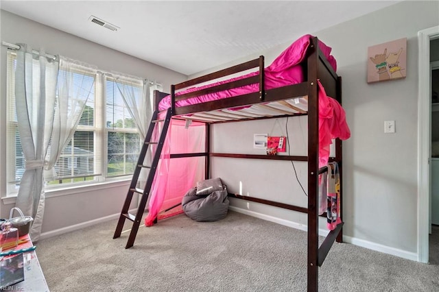 unfurnished bedroom with carpet floors, baseboards, and visible vents