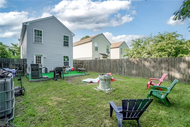 rear view of property with a fenced backyard, a patio, and a yard