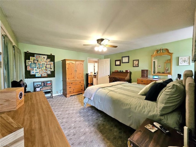 bedroom with a ceiling fan, baseboards, and light colored carpet