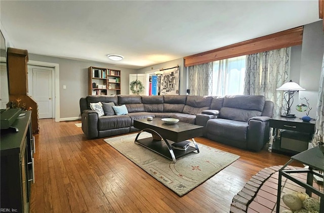 living room with baseboards and hardwood / wood-style flooring