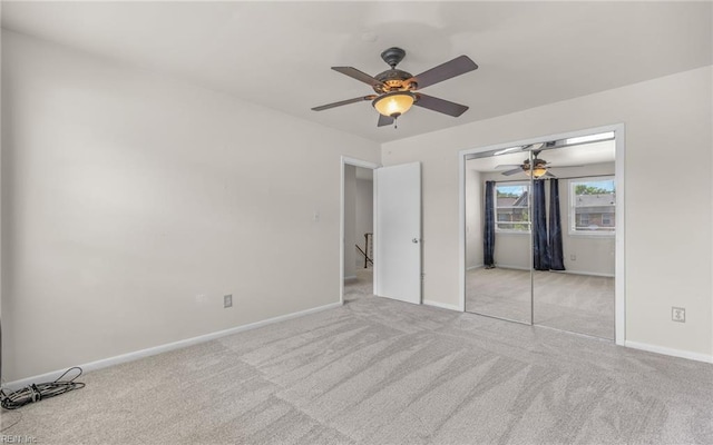 unfurnished bedroom featuring baseboards, carpet, and ceiling fan