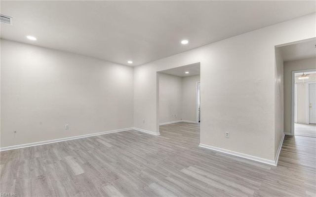 empty room featuring baseboards, recessed lighting, and light wood-style flooring