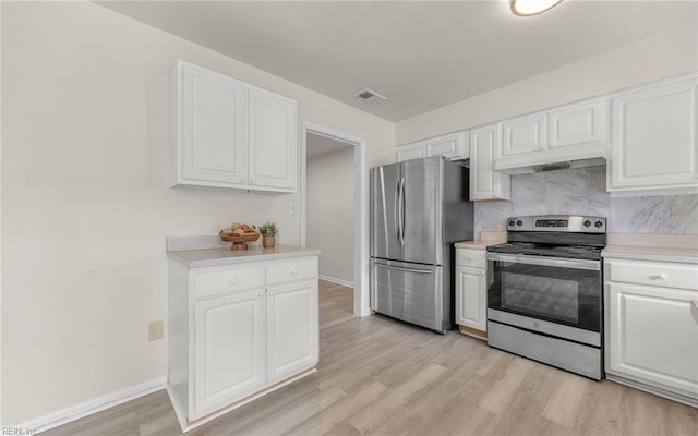 kitchen with visible vents, light wood-type flooring, light countertops, white cabinets, and appliances with stainless steel finishes