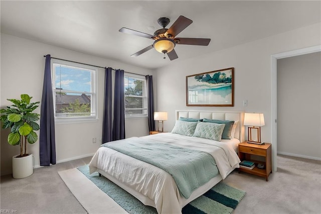 bedroom with baseboards, light carpet, and a ceiling fan