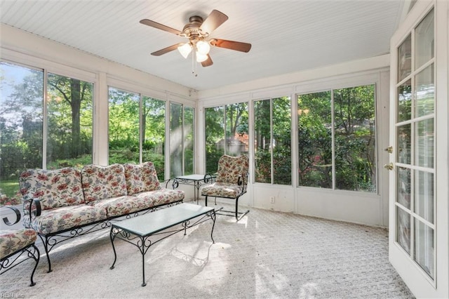 sunroom featuring ceiling fan and an outdoor living space