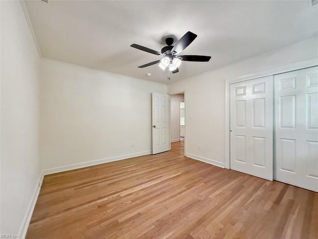 unfurnished bedroom with baseboards, ceiling fan, light wood-style flooring, and a closet