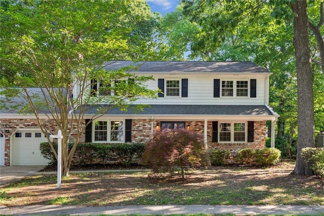 traditional-style home with an attached garage, driveway, and brick siding