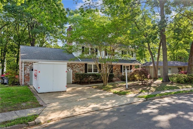 view of front of property with concrete driveway and brick siding