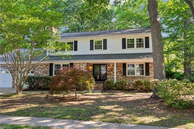 traditional home with an attached garage and brick siding