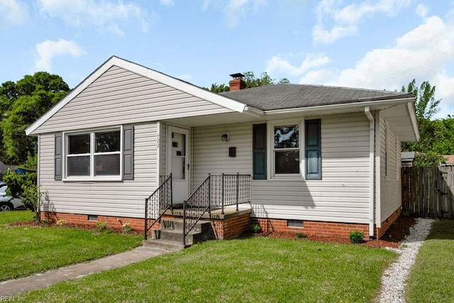 bungalow featuring crawl space, fence, a chimney, and a front yard