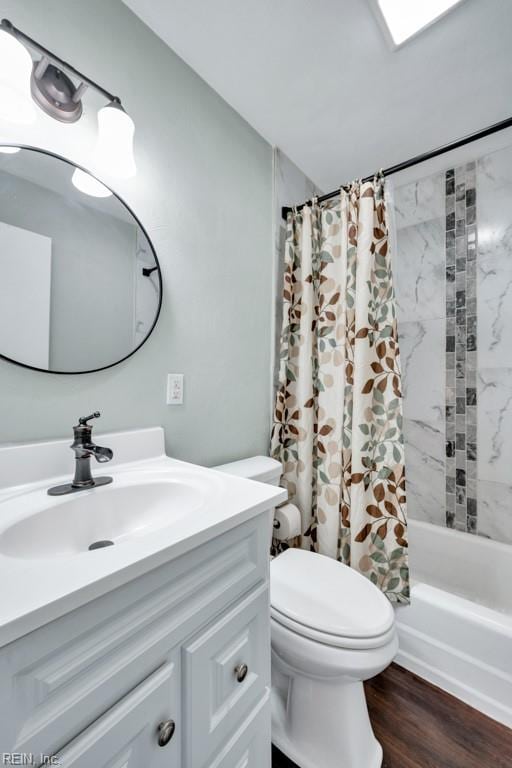 bathroom with vanity, shower / bath combo with shower curtain, toilet, and wood finished floors
