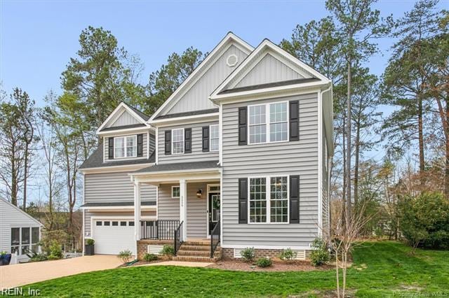 3009 Ridge Dr, Toano, VA 23168 - view of front facade with a garage, a front lawn, board and batten siding, concrete driveway, and a porch