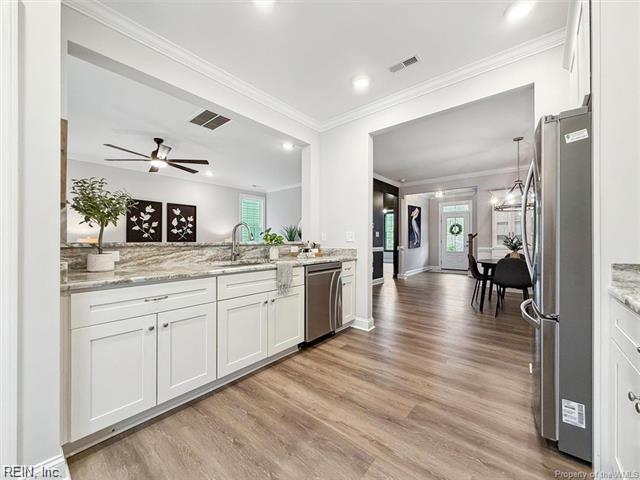 3009 Ridge Dr, Toano, VA 23168 - kitchen featuring visible vents, light wood-style flooring, a sink, stainless steel appliances, and white cabinetry