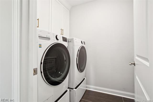 3009 Ridge Dr, Toano, VA 23168 - washroom with cabinet space, separate washer and dryer, baseboards, and dark wood-style flooring