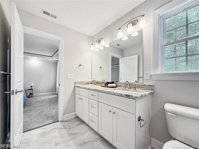 3009 Ridge Dr, Toano, VA 23168 - bathroom with double vanity, visible vents, a sink, toilet, and marble finish floor