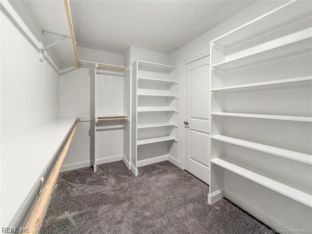 3009 Ridge Dr, Toano, VA 23168 - walk in closet with dark carpet