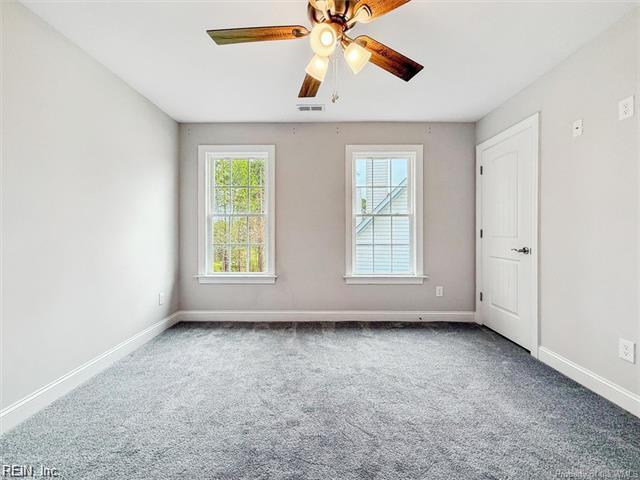 3009 Ridge Dr, Toano, VA 23168 - carpeted empty room with baseboards, a ceiling fan, and visible vents