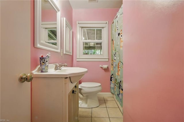 bathroom with tile patterned flooring, vanity, toilet, baseboards, and a shower with curtain