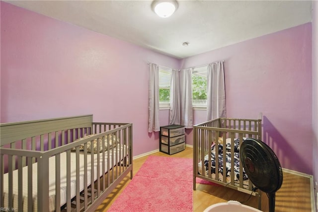 bedroom with baseboards and wood finished floors