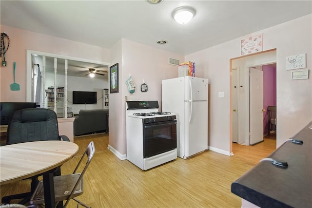 kitchen with ceiling fan, light wood finished floors, white appliances, baseboards, and visible vents