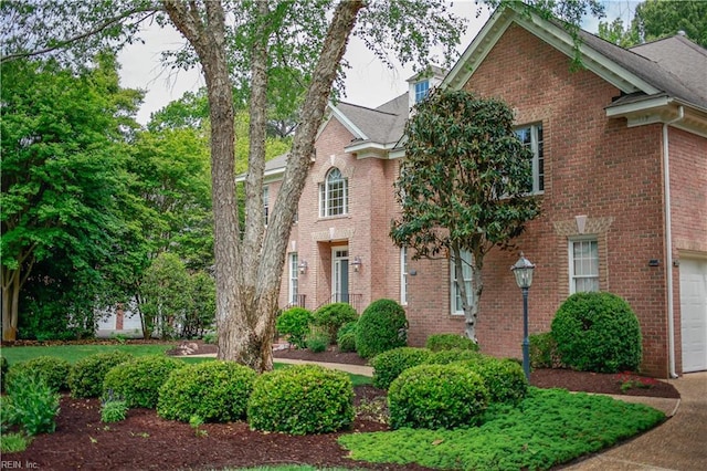 view of front of house with brick siding and a garage