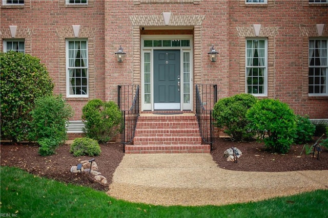 doorway to property with brick siding