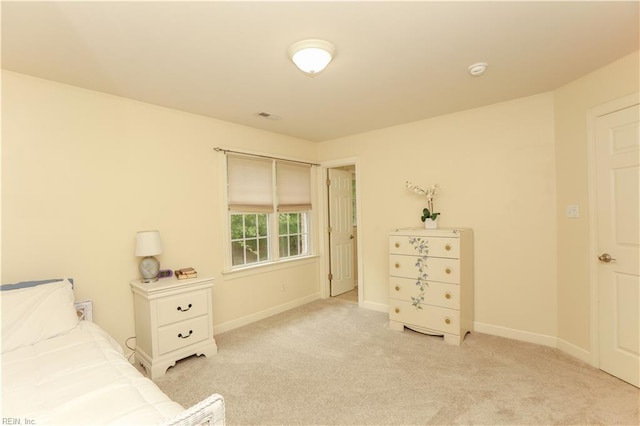 bedroom featuring baseboards, visible vents, and light colored carpet