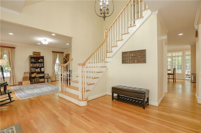 staircase featuring recessed lighting, ornamental molding, baseboards, and wood finished floors