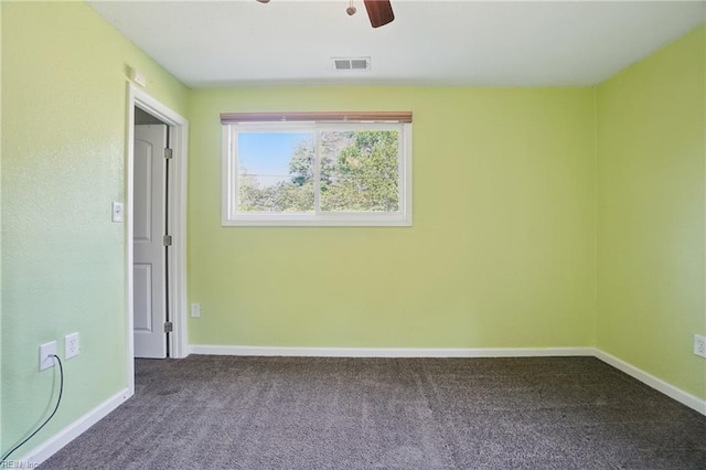 carpeted empty room featuring baseboards, ceiling fan, and visible vents