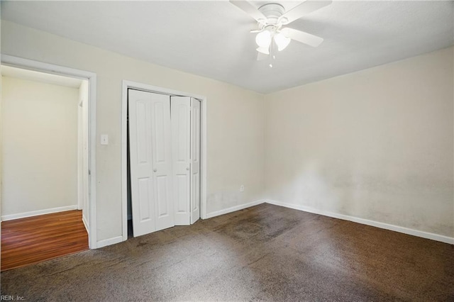 unfurnished bedroom with baseboards, ceiling fan, carpet, and a closet
