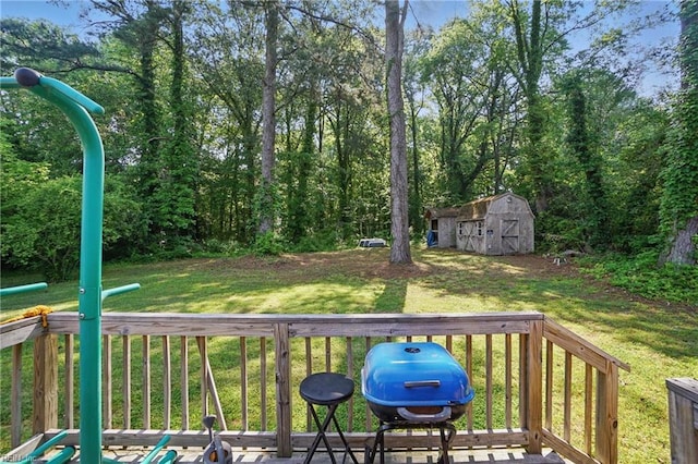 wooden terrace featuring a lawn, an outdoor structure, area for grilling, and a storage unit