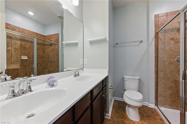 bathroom with a sink, toilet, and a shower stall