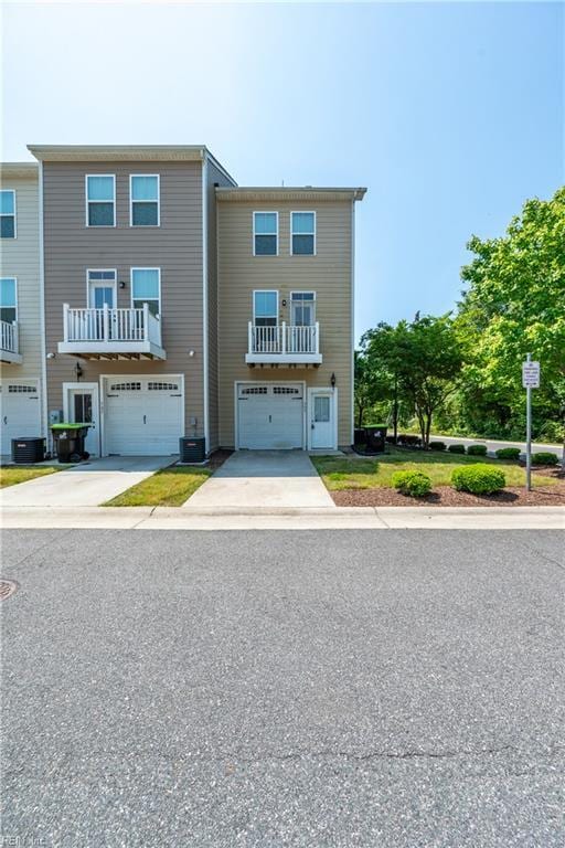multi unit property featuring a garage and driveway