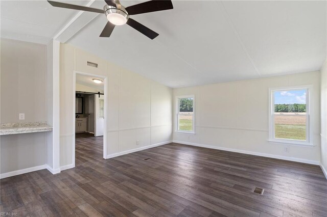empty room featuring visible vents, lofted ceiling with beams, and dark wood-style flooring