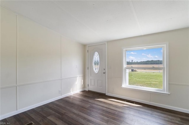 entryway with baseboards and wood finished floors