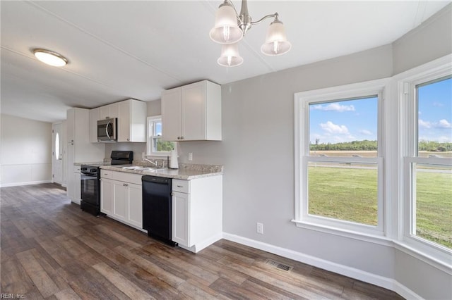 kitchen with baseboards, visible vents, black appliances, and dark wood-style floors