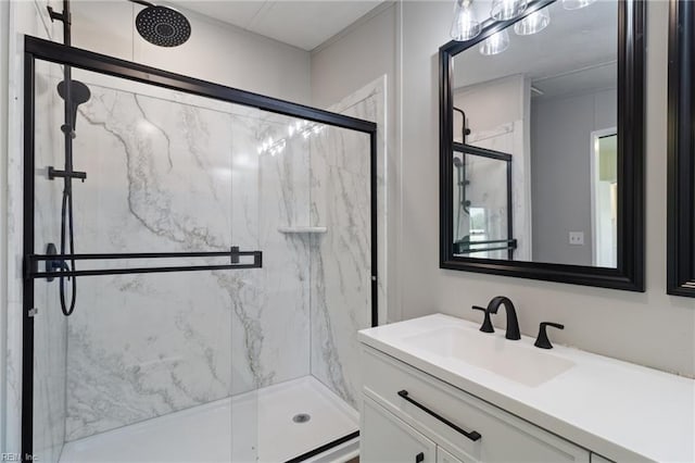bathroom with vanity and a marble finish shower