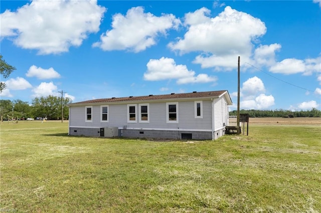 back of property with a yard and crawl space