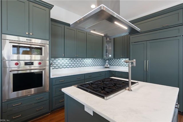 kitchen with appliances with stainless steel finishes, tasteful backsplash, ventilation hood, dark wood-style floors, and glass insert cabinets