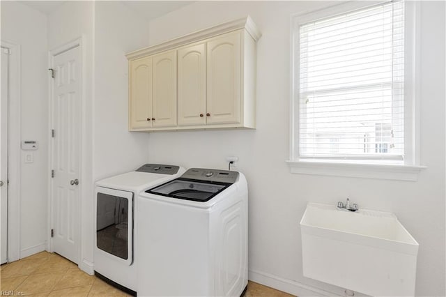 laundry room with a sink, cabinet space, and independent washer and dryer