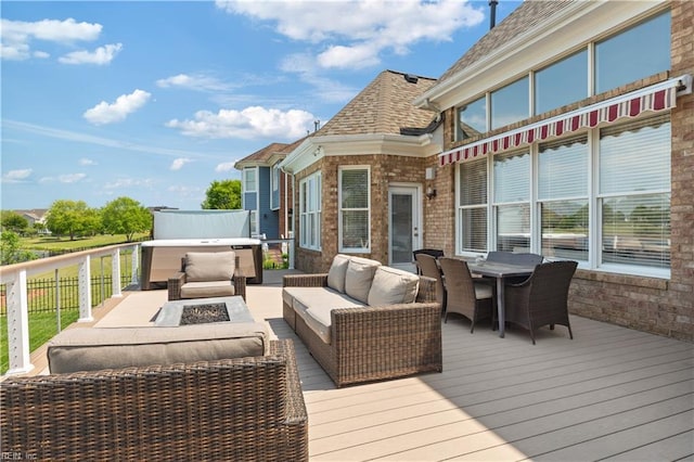 wooden terrace featuring an outdoor living space with a fire pit and outdoor dining space