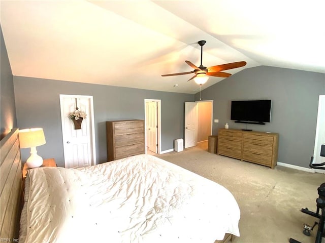 bedroom featuring carpet floors, baseboards, ceiling fan, and vaulted ceiling