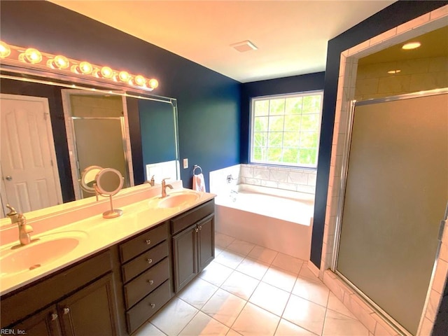 bathroom with a sink, a shower stall, and a garden tub